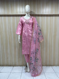 pink gold traditional outfit with a dupatta on a mannequin against a striped