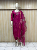 dark pink gold traditional outfit with a dupatta on a mannequin against a striped