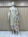 Mannequin wearing a white traditional outfit with a floral dupatta against a striped