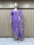 Mannequin wearing a purple traditional outfit with a floral dupatta against a striped