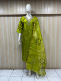 Mannequin wearing a green traditional outfit with a matching dupatta against a striped