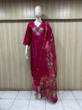 Mannequin wearing a red floral dress against a striped