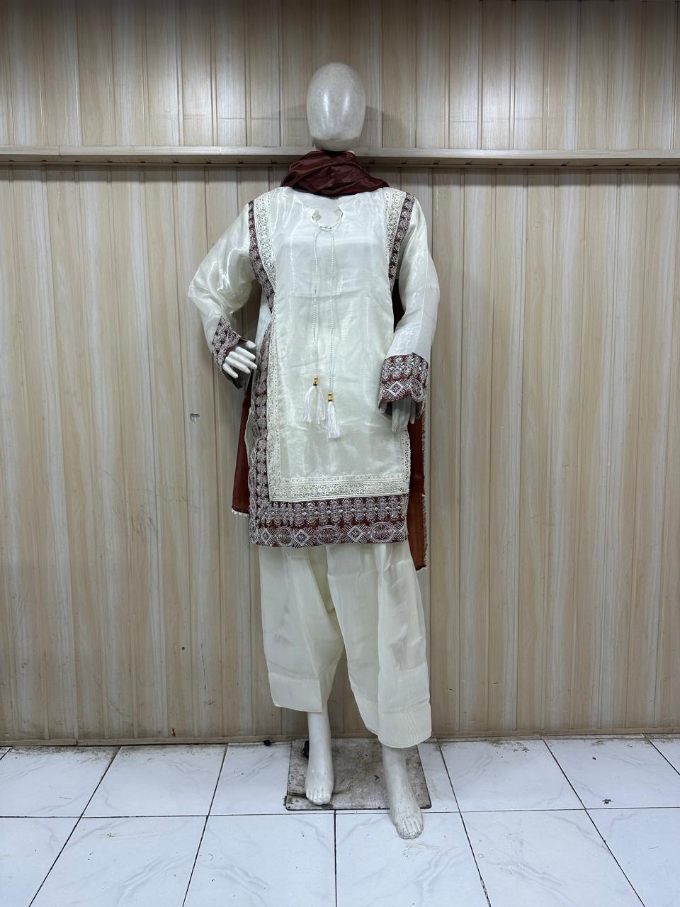 Mannequin wearing a white floral dress against a striped