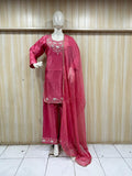 Mannequin wearing a red traditional outfit with a floral dupatta against a striped