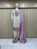 Mannequin wearing a white and pink traditional outfit with a floral dupatta against a striped