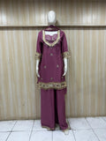 Mannequin wearing a rose gold traditional outfit with a floral dupatta against a striped