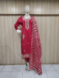 Red embroidered dress with a matching dupatta on a mannequin against a striped