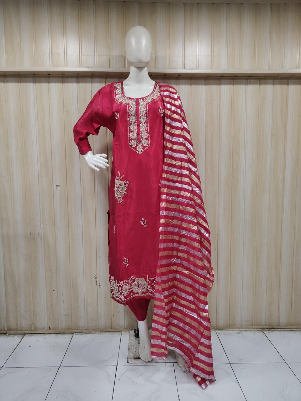 Red embroidered dress with a matching dupatta on a mannequin against a striped