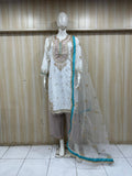 white and grey embroidered dress with a matching dupatta on a mannequin against a striped