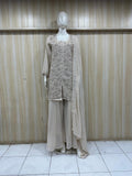gray embroidered dress with a matching dupatta on a mannequin against a striped