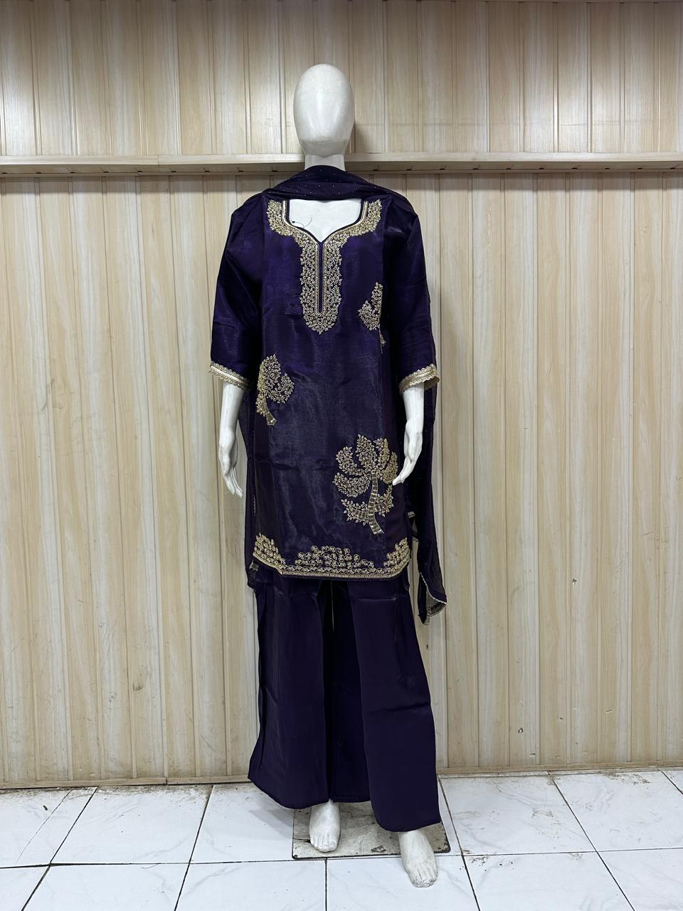 nave blue embroidered dress with a matching dupatta on a mannequin against a striped