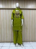 green embroidered dress with a matching dupatta on a mannequin against a striped
