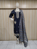 oranj embroidered dress with a matching dupatta on a mannequin against a striped