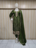 green gold embroidered dress with a matching dupatta on a mannequin against a striped