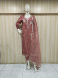 rose gold embroidered dress with a matching dupatta on a mannequin against a striped