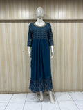 mannequin wearing a nevy blue floral dress outfit with Traditional against a wooden panel background